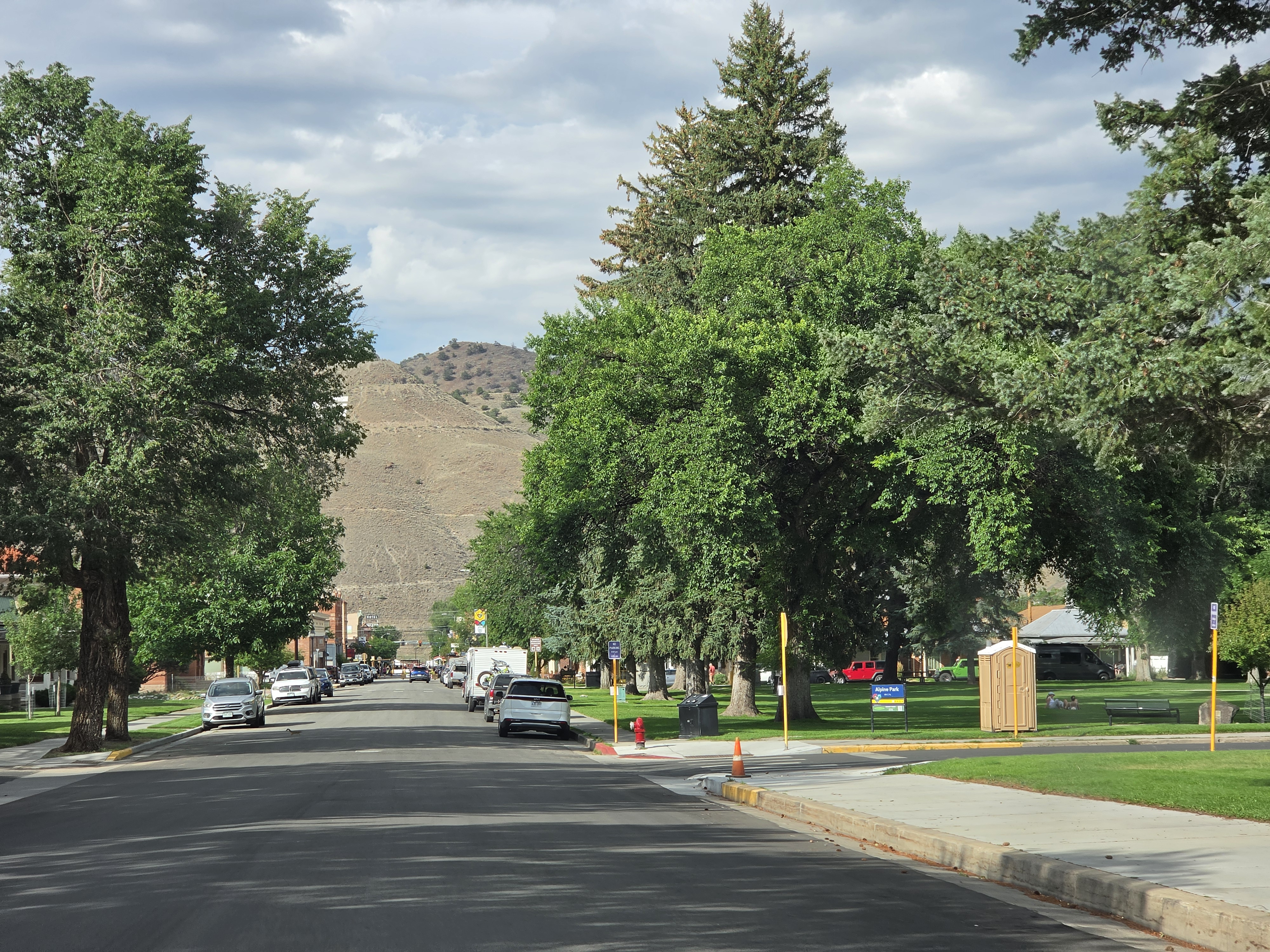 Tree-lined street in Salida with the S mountain on the hillside behind town