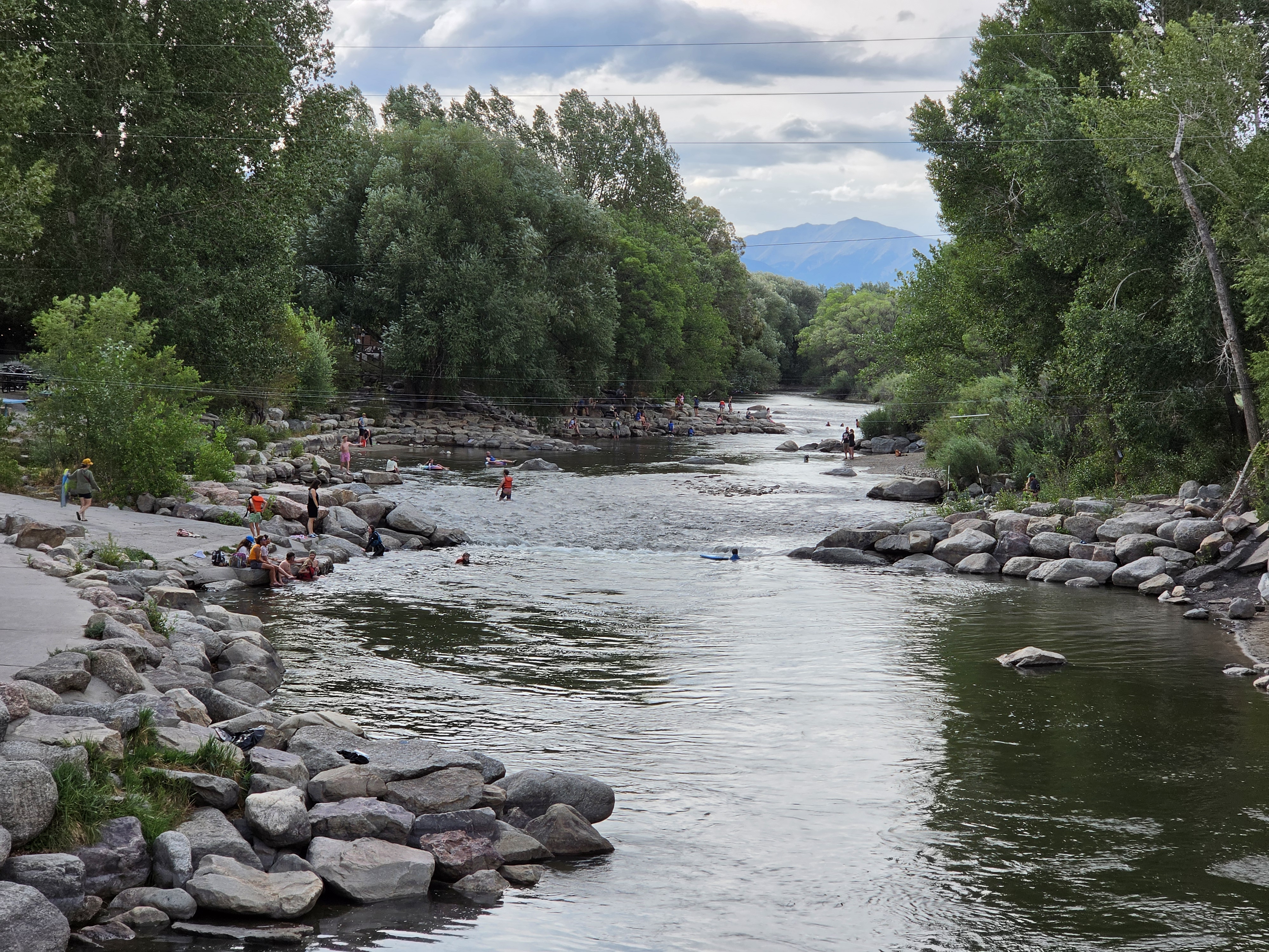 People playing in the whitewater park on the Arkansas River in Salida