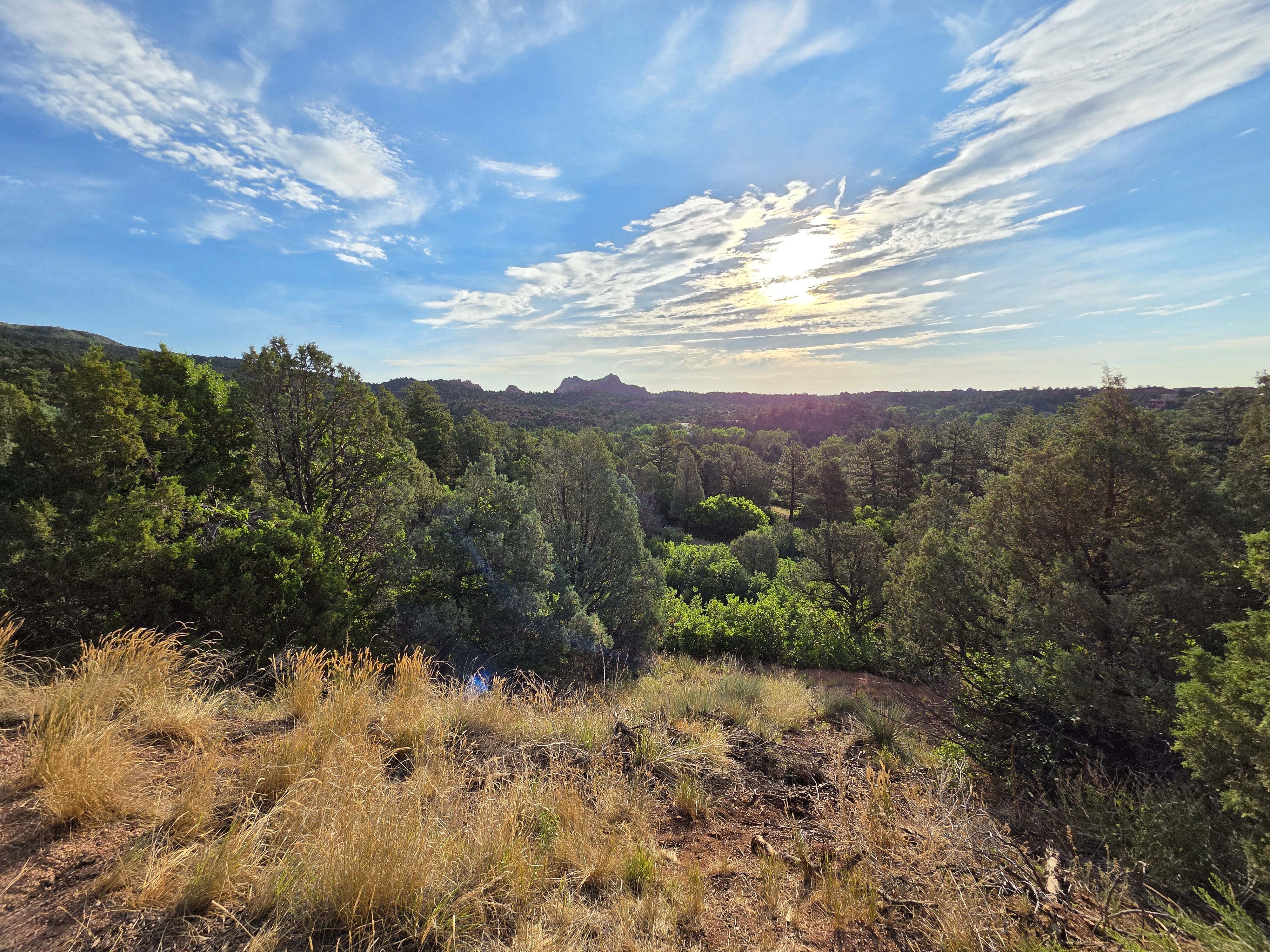 Sunrise over the valley at Garden of the Gods, red rock formations in the distance